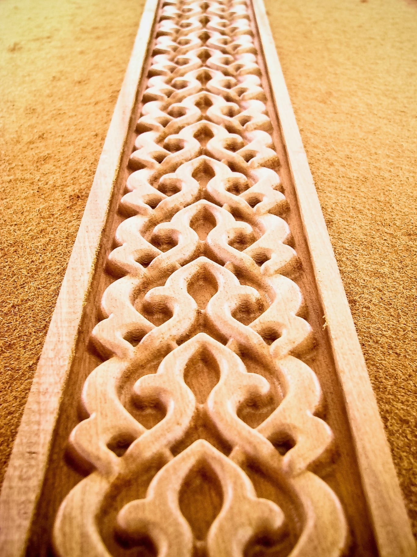 CNC carved wooden border trim with repeating arabesque pattern